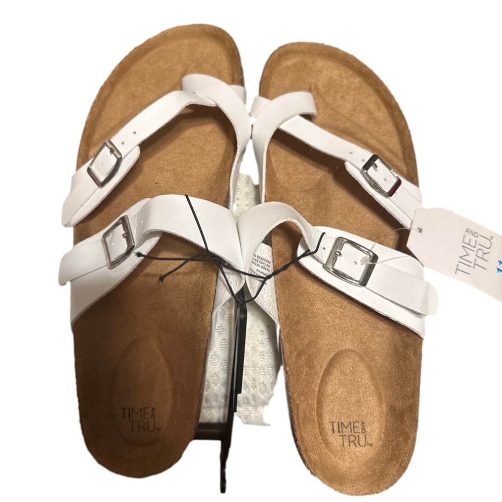 White toe strap Wide with leather sandals with a cork thick sole .